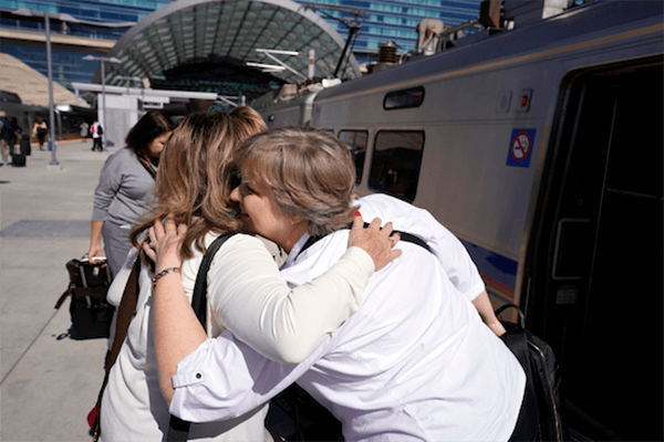 Two people hugging | Personalized support for Luxury Travel Advisors - Andavo Travel | Luxury Travel Agency